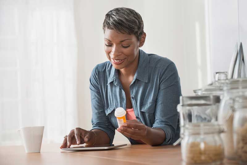 woman looks at medication label